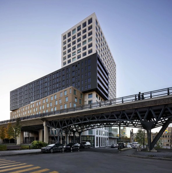 A white tower and dark mid-rise block above the elevated walkway at Gare Viger