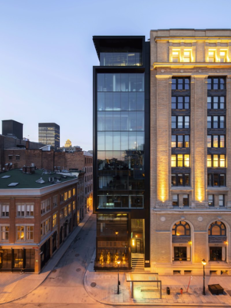 The Édifice Shaughnessy at 407 McGill, stone façade with a glass addition